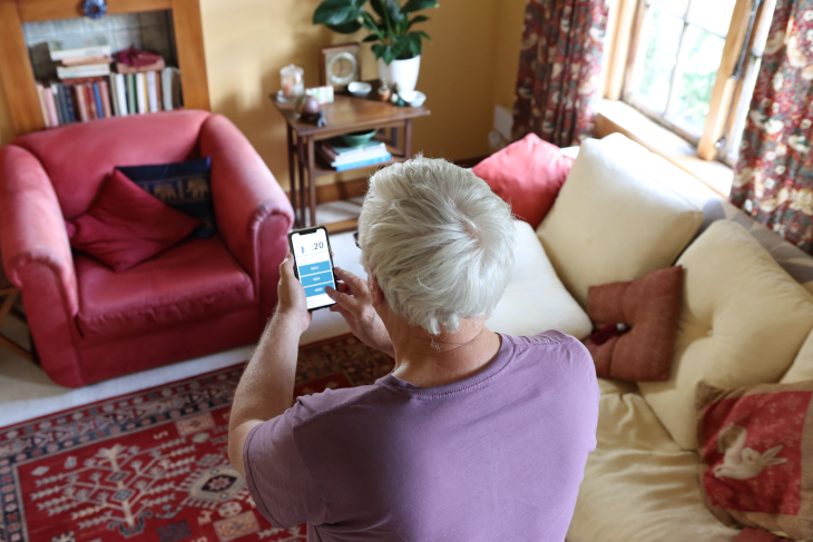 An older person using the Nymbl app on their phone. 