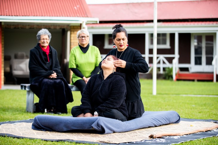 A rongoa Māori practitioner provides healing to a client.