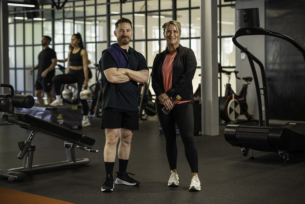 two people standing in a gym