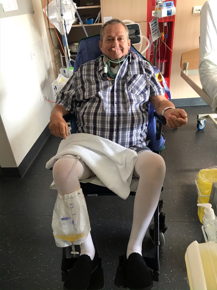 George Thompson sitting in a wheelchair in hospital.