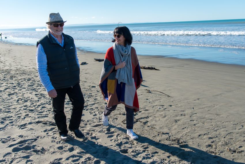 Man and woman walking on beach