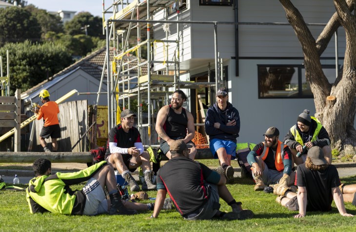 Builders relax on the lawn at a job site