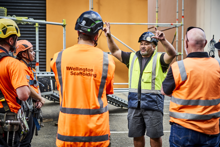A manager talking to his workers on a construction site. 