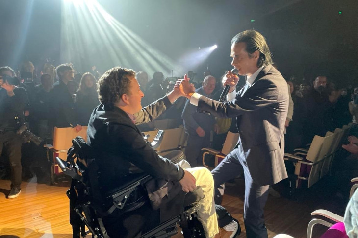 Dr Johnny Bourke shakes hands with legendary Australian singer, songwriter and author Nick Cave