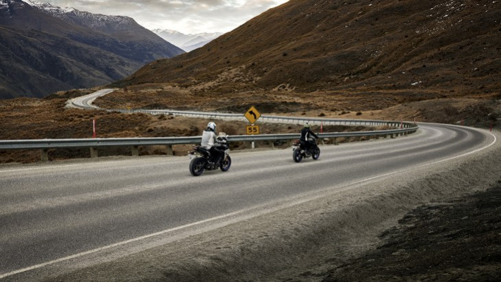 Two motorbikes cruise through the crown ranges