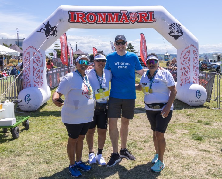 Andy Milne posing for a photo with several organisers at IronMāori.