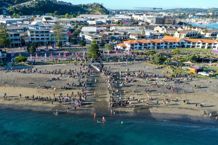 A wide-angle aerial photo showing part of the IronMāori course on a beach. 