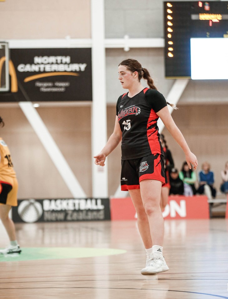 Lauren on the court, playing for the Canterbury Wildcats basketball team.
