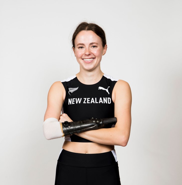 A portrait photo of a smiling Anna Grimaldi wearing her black New Zealand athletics uniform.