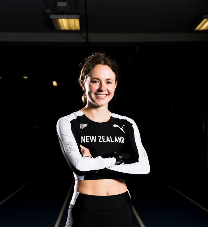 A portrait photo of a smiling Anna Grimaldi wearing her black New Zealand athletics uniform.