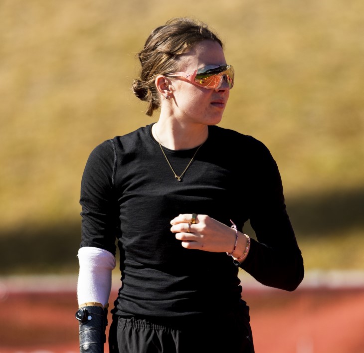 A side-on shot of Anna Grimaldi, who is wearing sunglasses and athletics clothing on the track.