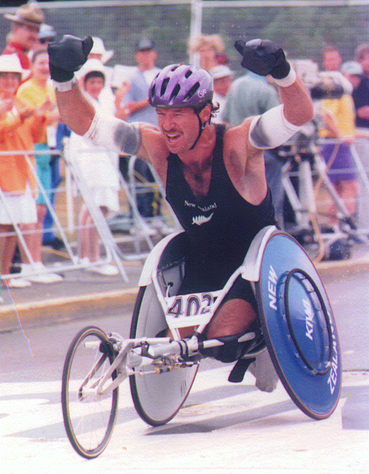 Ben Lucas raising his hands in celebration while competing for New Zealand in wheelchair racing.