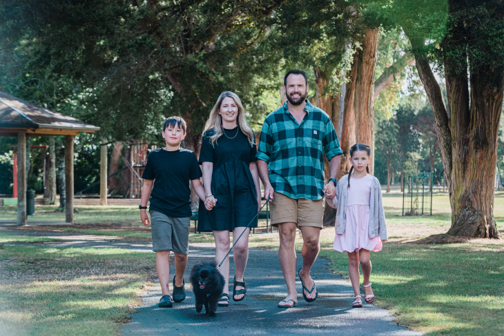 Blake Jones and his family in a park walking toward the camera.