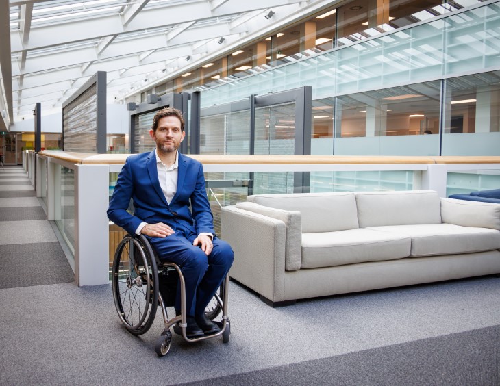 Dan Buckingham sitting in his wheelchair in an office building.