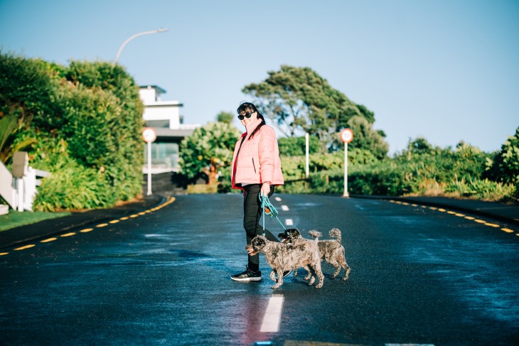 Diane Alder crossing the road with her two dogs. 
