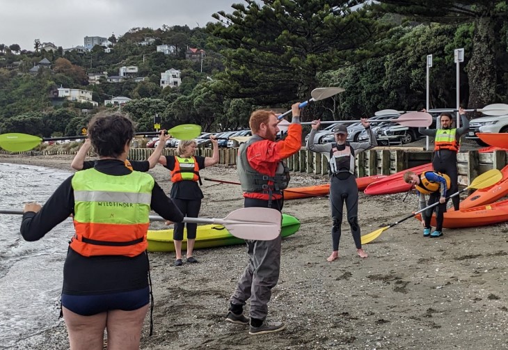 A kayak instructor taking a class through safety training. 