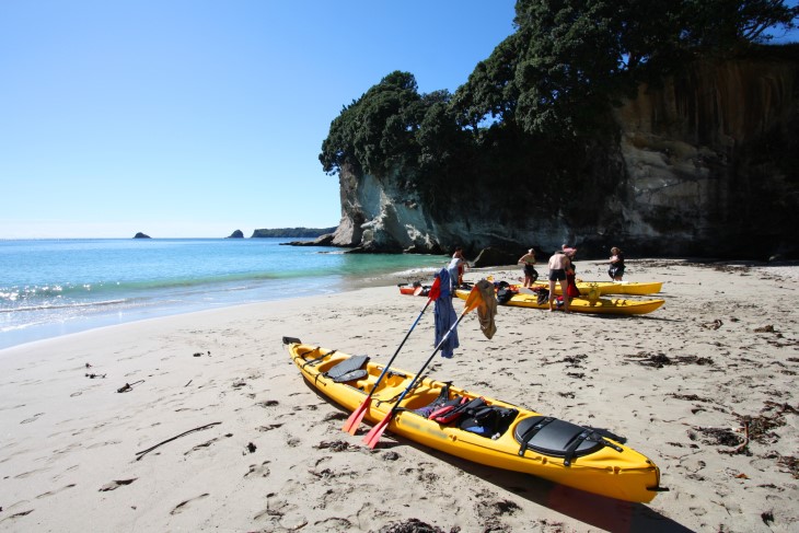 Kayakers on the beach after a paddle.