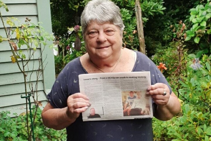 Lesley Cotter holding up a copy of Jason's story in the Ruapehu Bulletin.