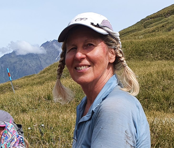 A portrait photo of Liz Wightwick on a mountain range.