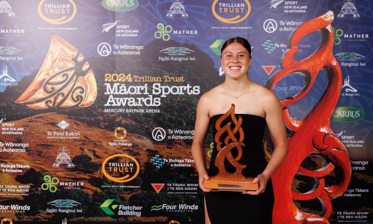 Maia Davis posing with her Junior Māori Sportswoman of the Year award.