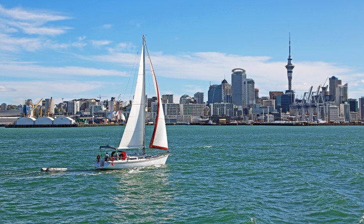 A sail boat coming into Auckland Harbour towards the city. 