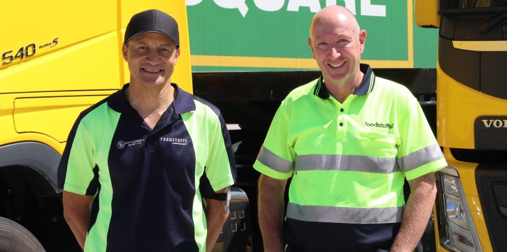 HARMfree supporters Mike Ruki Willison and John Baillie wearing high-vis vests in front of a truck. 