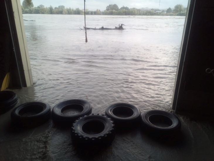A photo showing water surrounding the shed of the Adventure Wairoa Sports Club.
