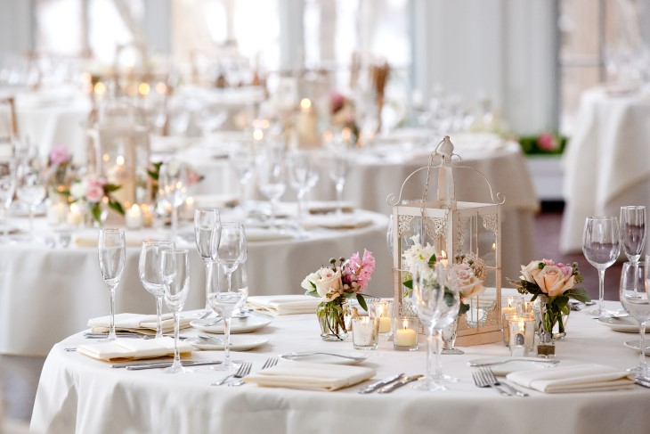 Tables set out for a fine-dining wedding ceremony. 