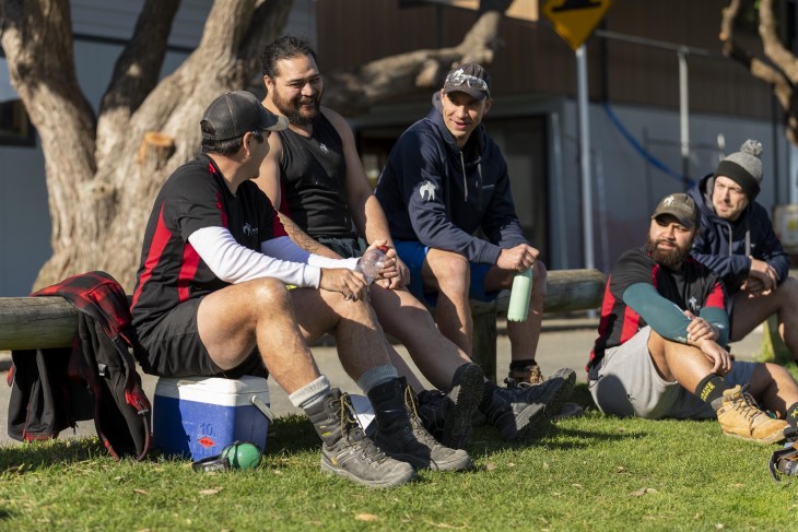 A group of workers sitting outside having lunch.