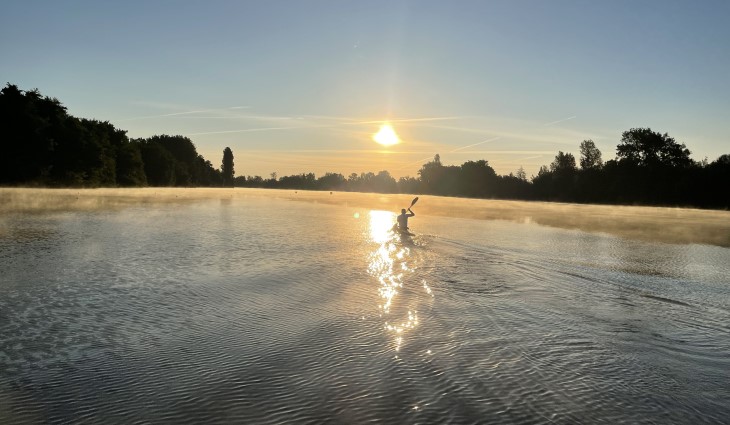 Scott Martlew paddling towards a beautiful sunset during training.